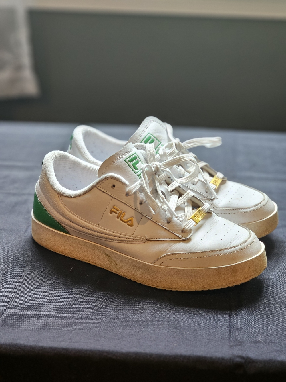Fila White Sneakers with Green Accents and Gold Logo Hardware